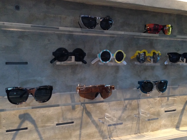 A wall display of Linda Farrow sunglasses at The Celect